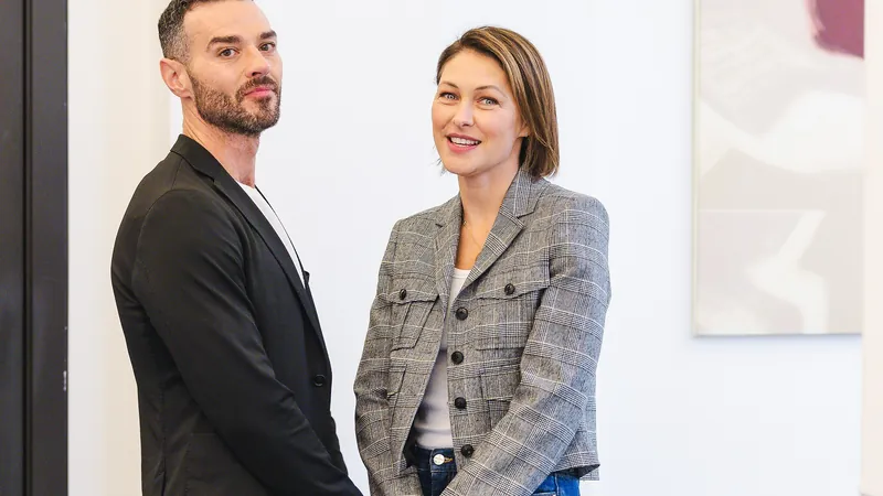Love Is Blind: UK hosts Matt and Emma Willis standing together in an office